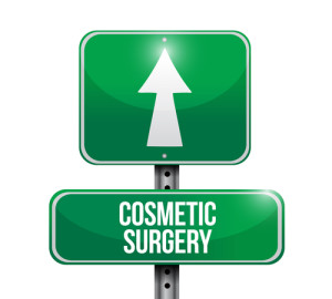 A green traffic sign with an up arrow and "COSMETIC SURGERY" written above it